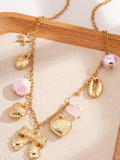 Collier punk vintage avec pendentifs multiples et nœud cœur